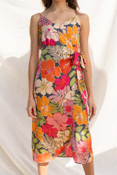 Crafted from luxurious satin fabric, it features adjustable straps and a tie front detail that flatters the figure. Including a dramatic tropical print.