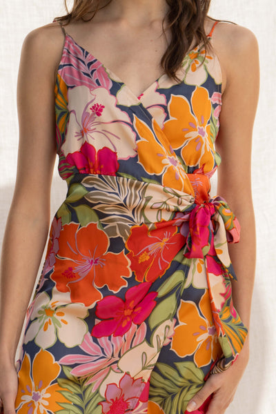 Crafted from luxurious satin fabric, it features adjustable straps and a tie front detail that flatters the figure. Including a dramatic tropical print.
