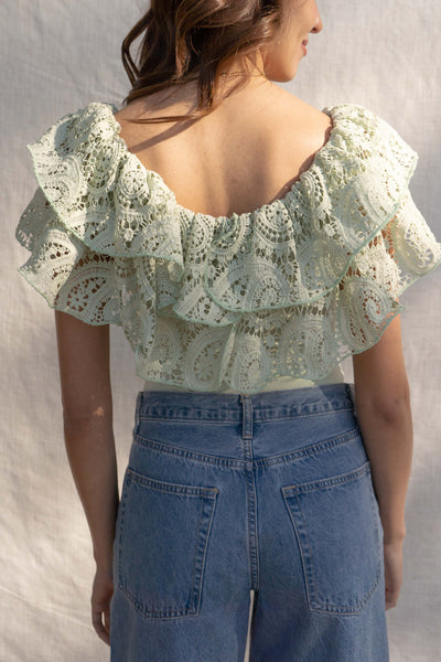 With a fitted silhouette, this versatile bodysuit features crochet and ruffle detailing, crafted for a unique style. sage color.