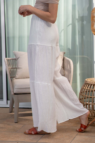 These wide leg bottoms feature a comfy elastic waistband and stylish tiered details. white color. slip underneath.