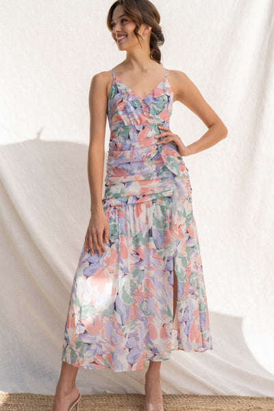 Featuring a beautiful floral water color print, thin straps, and delicate ruffle detail, you'll look chic and elegant in this fitted dress.