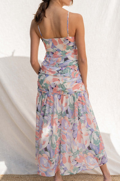 Featuring a beautiful floral water color print, thin straps, and delicate ruffle detail, you'll look chic and elegant in this fitted dress.