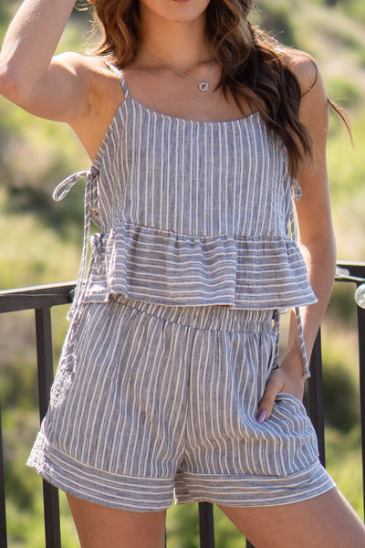 Stripe babydoll cami top. Lightweight top features spaghetti straps and adjustable side ties.