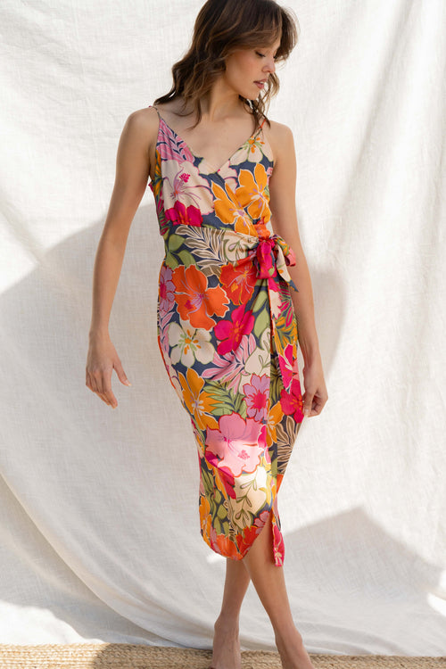Crafted from luxurious satin fabric, it features adjustable straps and a tie front detail that flatters the figure. Including a dramatic tropical print.