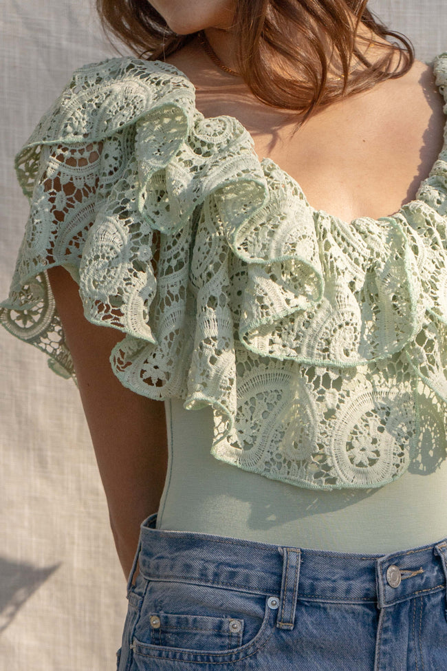 With a fitted silhouette, this versatile bodysuit features crochet and ruffle detailing, crafted for a unique style. sage color.