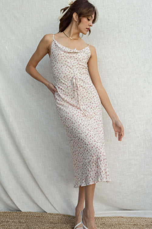 With its delicate cowl neckline and thin straps, it exudes an elegant yet playful charm.
