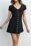 This short-sleeved dress features a tight fit and buttons along the middle. black color.