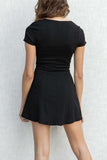 This short-sleeved dress features a tight fit and buttons along the middle. black color.