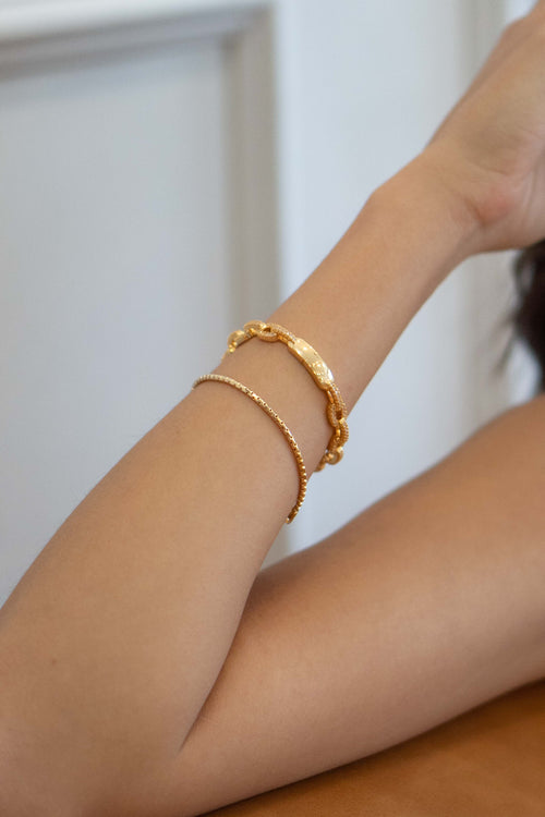 Crafted from thin and lightweight gold colored metal, it's easy to layer for a fashionable finish.