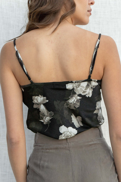 Featuring a delicate floral print, thin straps, and a stylish cowl neckline, this top offers a relaxed slip fit that flatters any body type. black color.