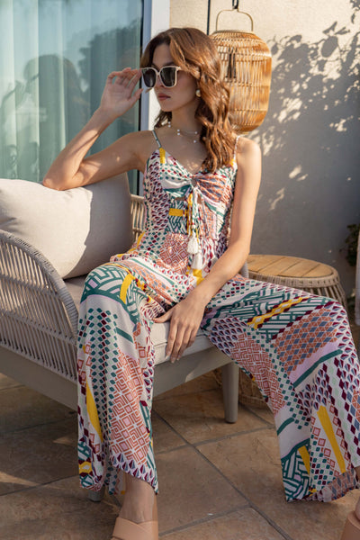 Featuring thin straps, a keyhole neckline, and a smocking bodice, this jumpsuit offers a relaxed, yet flattering fit. The wide leg and fun, bright print make it perfect for any vacation.