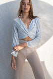 The lightweight gauze material offers ultimate comfort while the knot detail and plunge neckline add a touch of style. With long sleeves and a relaxed fit. light blue.