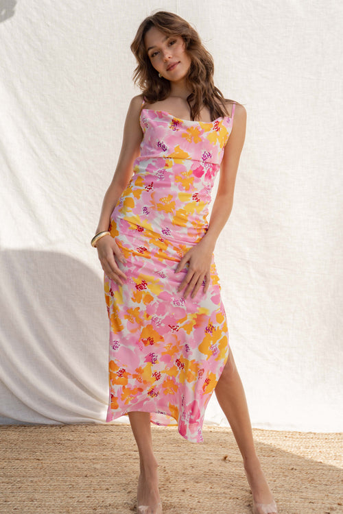 Featuring a pop of color, thin straps, cowl neckline, and ruching slit detail, you'll turn heads in this beautiful floral print.