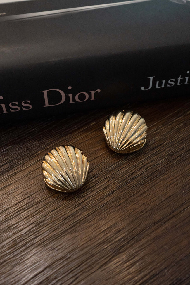 The unique seashell design and bold clasp detail make these earrings a statement piece . gold color.