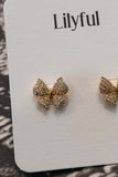 These elegant earrings feature a bow tie design with rhinestone details, making them perfect for any occasion.