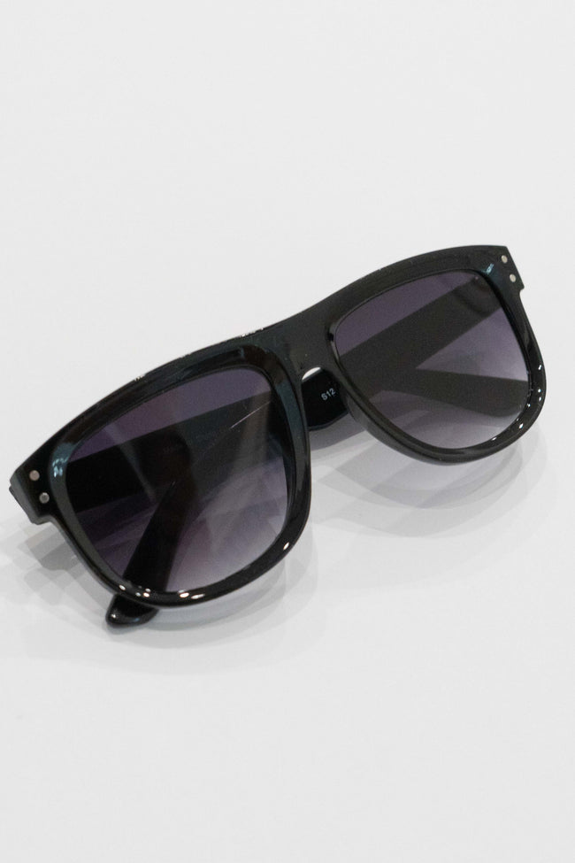 Flat top, black sunglasses.