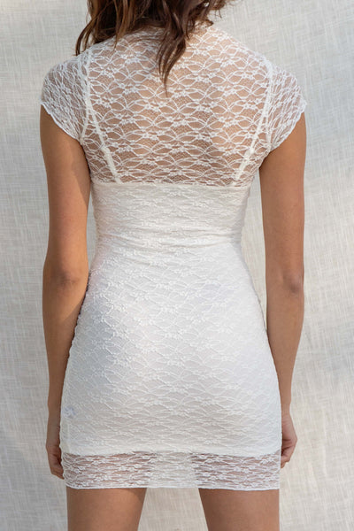 This stretchy and fitted mini is perfect for any event or night out. With delicate lace detailing and a slip underneath. white color.