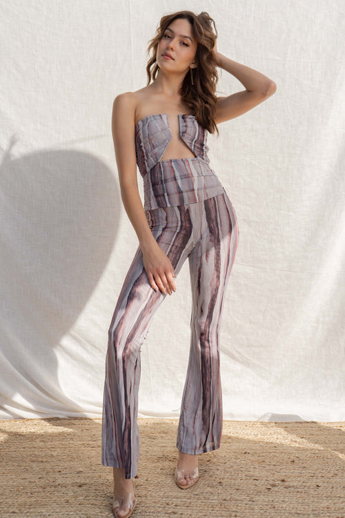 Strapless with a daring plunge neckline, this stretchy jumpsuit offers a tight fit for a flattering silhouette.