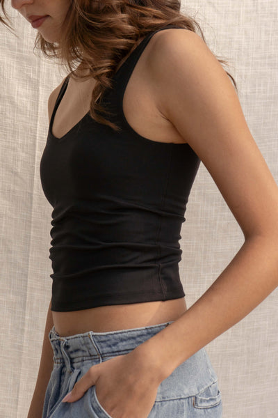 This basic crop top features breast padding for extra support and comes in three trendy colors. Its stretchy and comfortable fit makes it perfect for any occasion. black.