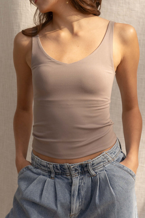 This basic crop top features breast padding for extra support and comes in three trendy colors. Its stretchy and comfortable fit makes it perfect for any occasion. dark taupe.