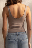 This basic crop top features breast padding for extra support and comes in three trendy colors. Its stretchy and comfortable fit makes it perfect for any occasion. dark taupe.
