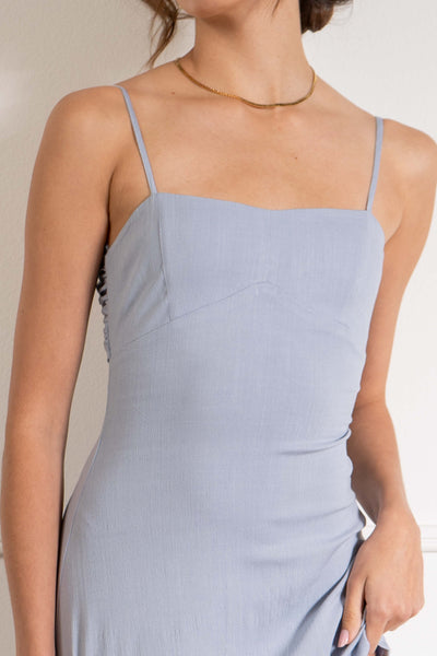 With a fitted silhouette and thin adjustable straps, this dress flatters the figure and allows for easy customization. The open back detail adds a touch of elegance. dusty blue.