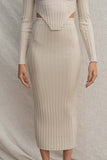 This ribbed two piece set includes a cropped long sleeve top and matching midi skirt, both stretchy and comfortable for a tight fit. oatmeal color.