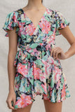 This Light Floral Wrap Dress features a flattering mini dress silhouette with wrap detail, tropical floral print, and an overlap V neckline. Short sleeves and light fabric make it perfect for warm-weather occasions.  