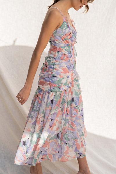 Featuring a beautiful floral water color print, thin straps, and delicate ruffle detail, you'll look chic and elegant in this fitted dress