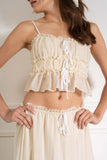 The ruffle and bow details add a touch of femininity to this two piece set. Crafted from high-quality fabric.