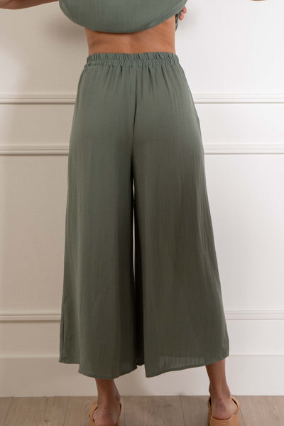 feature a comfortable elastic waistband and front pockets. sage color.