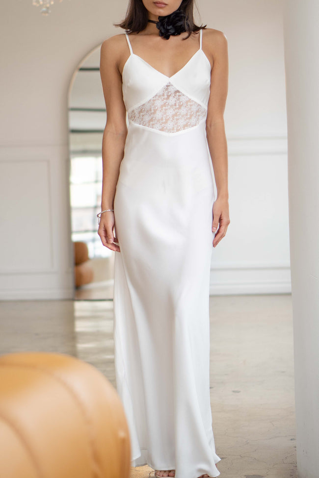 A sophisticated satin slip dress, it features elegant lace details, thin straps and a timeless maxi length.