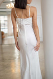A sophisticated satin slip dress, it features elegant lace details, thin straps and a timeless maxi length.