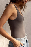 Its ribbed details, stretchy fabric, and comfortable fit make it perfect for everyday wear. With tank sleeves and a round neckline, it's available in two colors for all-day fun! charcoal colored.