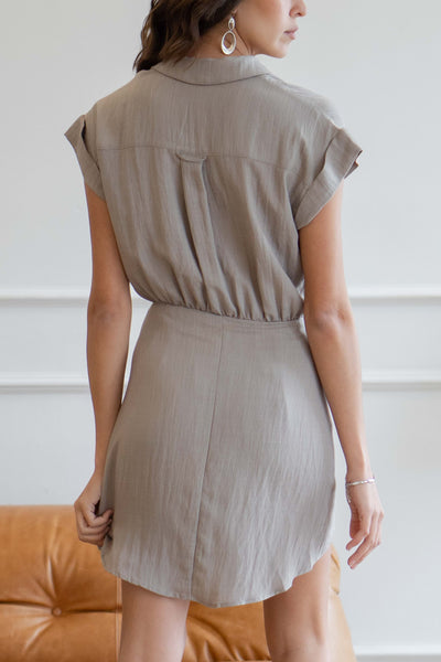 This short dress features button details, tie detail, and a relaxed fit.