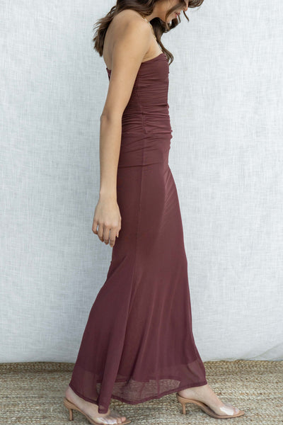 This stunning dress features a strapless design with a plunge neckline, creating a sexy yet elegant look. The mermaid flare and tight fit accentuate your curves. brown colored.
