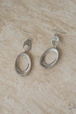 The earrings Featuring a large size and textured design.