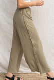 These palazzo bottoms feature a relaxed fit and linen details for a comfortable and stylish look. With an elastic waist band and buttons along the side. olive color.