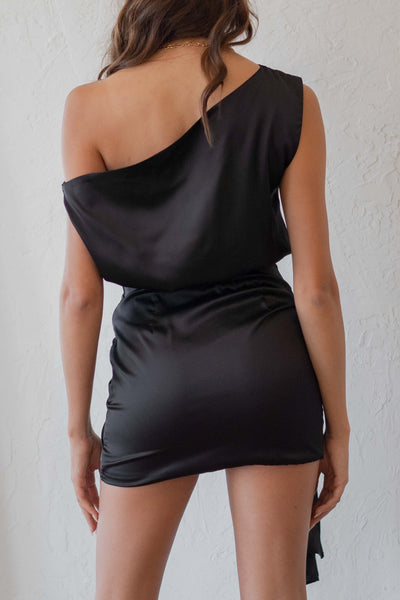 The mini dress is available in two colors and features a single shoulder and satin detailing for a striking look.