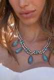 stone imbedded, teardrop shaped necklace.