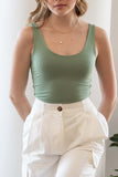 This scoop neck top features tank sleeves, crew neckline, double layered, and has a relaxed fit.