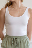 This scoop neck top features tank sleeves, crew neckline, double layered, and has a relaxed fit.