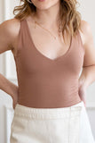 This tank top features tank sleeves, v neckline, double layered, and comes in multiple colors.