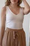 This tank top features tank sleeves, v neckline, double layered, and comes in multiple colors.